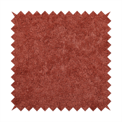A soft, textured fabric in a deep, warm reddish-terracotta shade. The surface features a dense, uniform, and plush pile, characteristic of thick fleece or absorbent material.