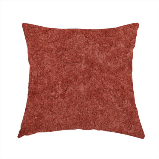 The fabric used to create this handmade cushion is a soft, textured fabric in a deep, warm reddish-terracotta shade. The surface features a dense, uniform, and plush pile, characteristic of thick fleece or absorbent material.
