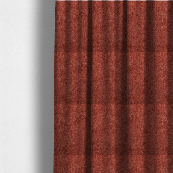 The fabric used to create these made-to-measure curtains is a soft, textured fabric in a deep, warm reddish-terracotta shade. The surface features a dense, uniform, and plush pile, characteristic of thick fleece or absorbent material.