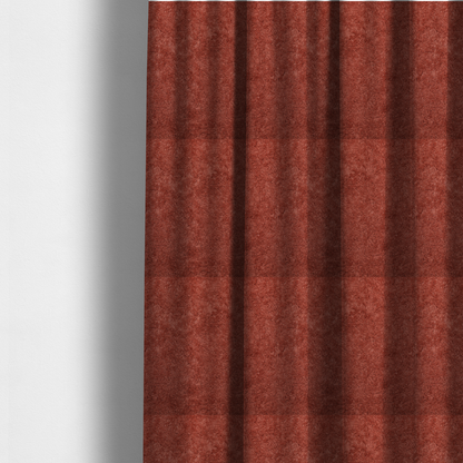 The fabric used to create these made-to-measure curtains is a soft, textured fabric in a deep, warm reddish-terracotta shade. The surface features a dense, uniform, and plush pile, characteristic of thick fleece or absorbent material.