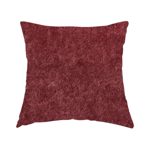 The fabric used to create this handmade cushion is a plush, deep burgundy fabric featuring a dense, uniform, and textured pile.