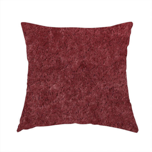 The fabric used to create this handmade cushion is a plush, deep burgundy fabric featuring a dense, uniform, and textured pile.