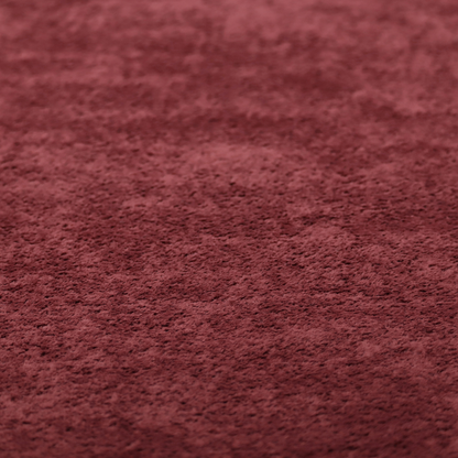 A plush, deep burgundy fabric featuring a dense, uniform, and textured pile.