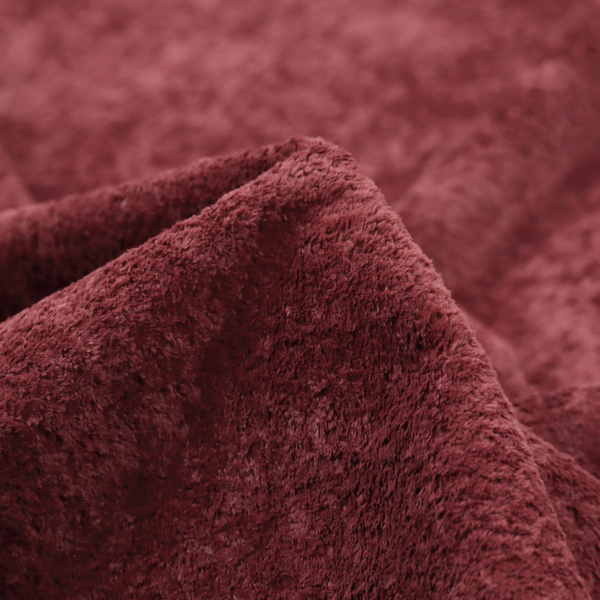A plush, deep burgundy fabric featuring a dense, uniform, and textured pile.