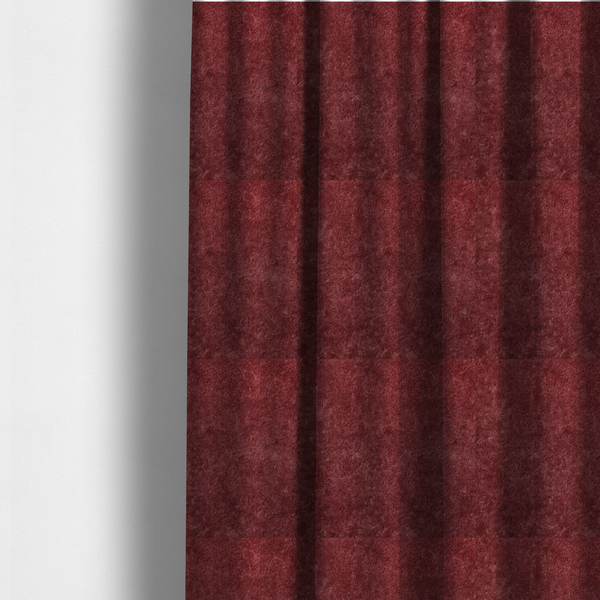 The fabric used to create these made-to-measure curtains is a plush, deep burgundy fabric featuring a dense, uniform, and textured pile.