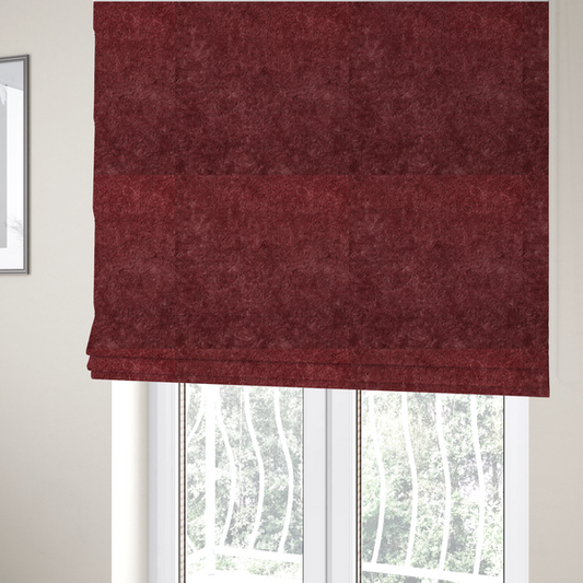 The fabric used to create these Roman blinds is a plush, deep burgundy fabric featuring a dense, uniform, and textured pile.