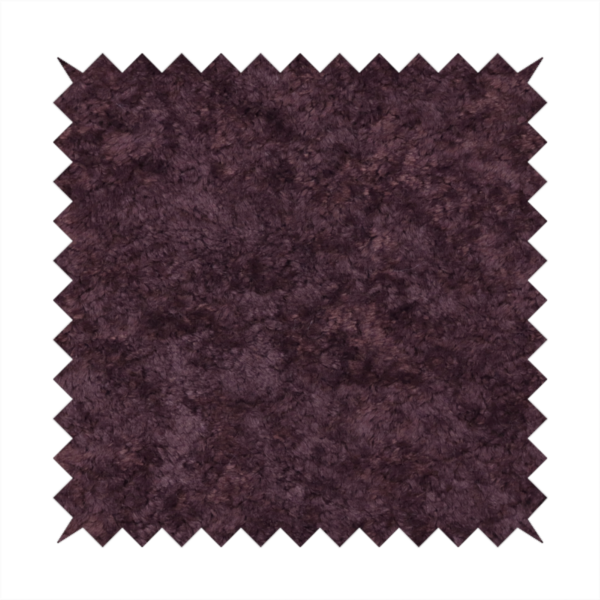 A plush, deep plum fabric featuring a dense, uniform, and textured pile.
