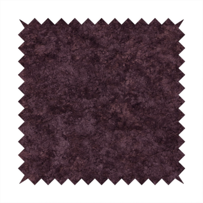 A plush, deep plum fabric featuring a dense, uniform, and textured pile.
