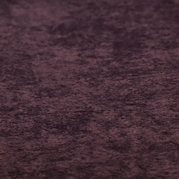 A plush, deep plum fabric featuring a dense, uniform, and textured pile.