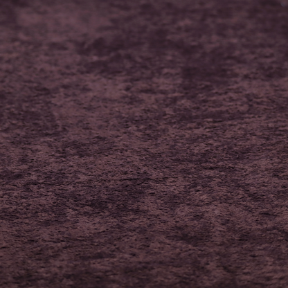 A plush, deep plum fabric featuring a dense, uniform, and textured pile.