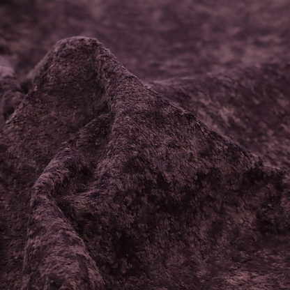 A plush, deep plum fabric featuring a dense, uniform, and textured pile.