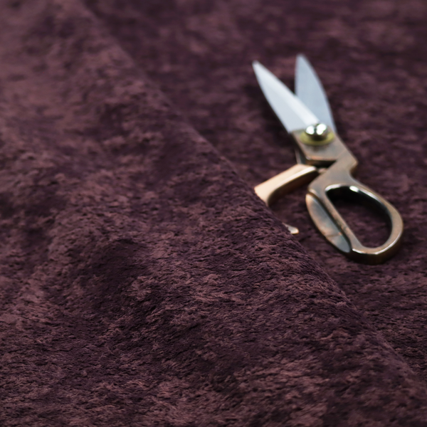 A plush, deep plum fabric featuring a dense, uniform, and textured pile.