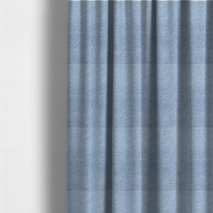The fabric used to create these made-to-measure curtains is a soft, light blue fabric with a dense, uniform, and plush pile.