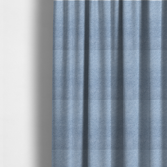 The fabric used to create these made-to-measure curtains is a soft, light blue fabric with a dense, uniform, and plush pile.