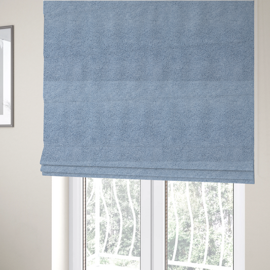 The fabric used to create these Roman blinds is a soft, light blue fabric with a dense, uniform, and plush pile.