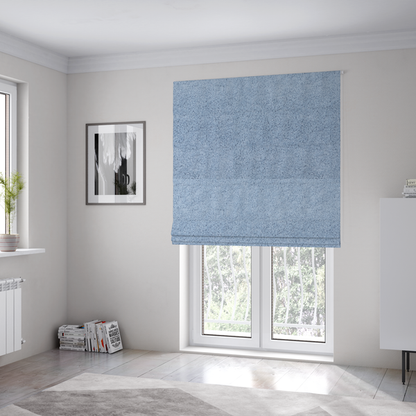 The fabric used to create these Roman blinds is a soft, light blue fabric with a dense, uniform, and plush pile.