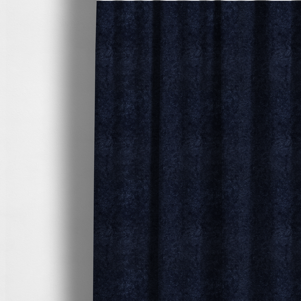 The fabric used to create these made-to-measure curtains is a soft, navy blue fabric featuring a dense, uniform, plush pile like thick fleece.