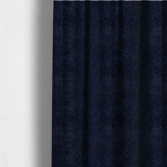 The fabric used to create these made-to-measure curtains is a soft, navy blue fabric featuring a dense, uniform, plush pile like thick fleece.