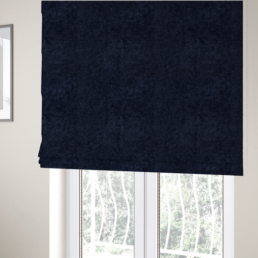 The fabric used to create these Roman blinds is a soft, navy blue fabric featuring a dense, uniform, plush pile like thick fleece.