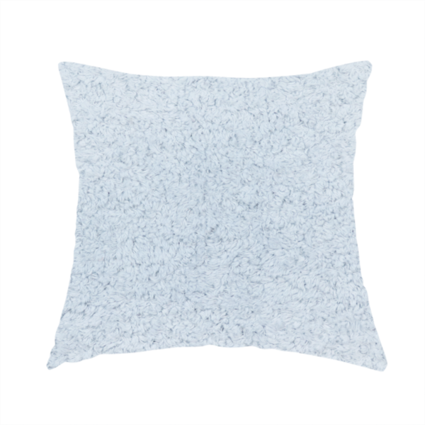 The fabric used to create this handmade cushion is a soft, pale blue fabric with a dense, uniform, and plush pile.