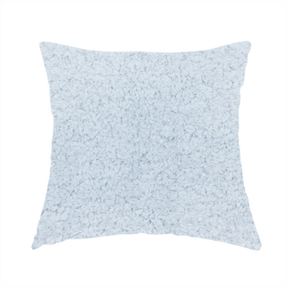 The fabric used to create this handmade cushion is a soft, pale blue fabric with a dense, uniform, and plush pile.