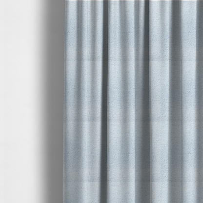 the fabric used to create these made-to-measure curtains is a soft, pale blue fabric with a dense, uniform, and plush pile.