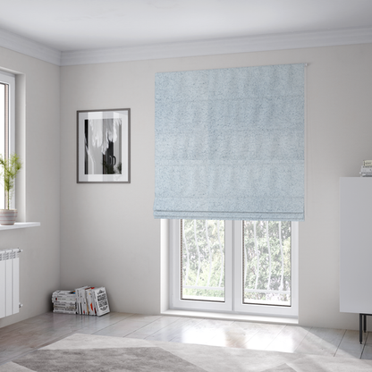The fabric used to create these Roman blinds is a soft, pale blue fabric with a dense, uniform, and plush pile.