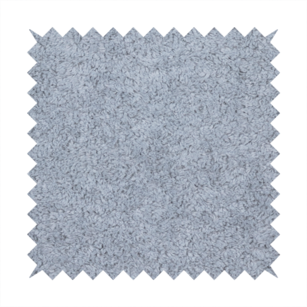 A soft greyish-blue fabric with a dense, uniform, textured pile like thick fleece.