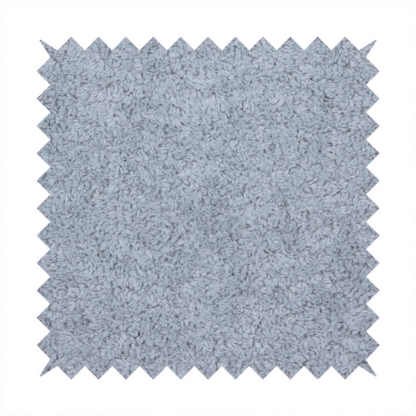 A soft greyish-blue fabric with a dense, uniform, textured pile like thick fleece.