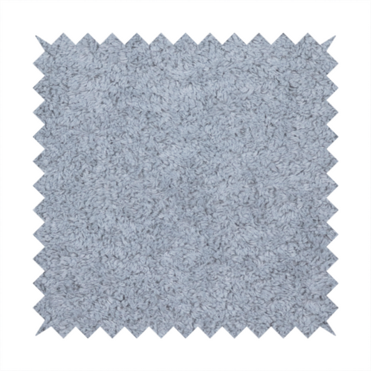 A soft greyish-blue fabric with a dense, uniform, textured pile like thick fleece.
