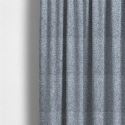 The fabric used to create these made-to-measure curtains is a soft greyish-blue fabric with a dense, uniform, textured pile like thick fleece.