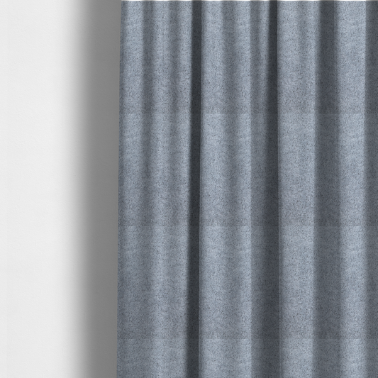 The fabric used to create these made-to-measure curtains is a soft greyish-blue fabric with a dense, uniform, textured pile like thick fleece.