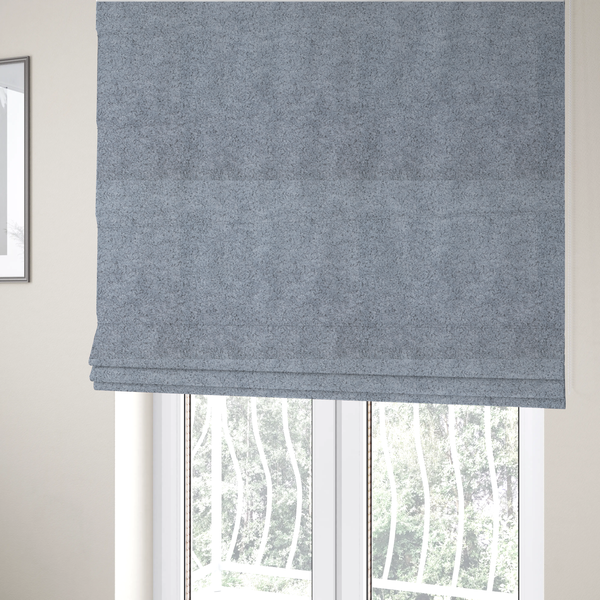 The fabric used to create these Roman blinds is a soft greyish-blue fabric with a dense, uniform, textured pile like thick fleece.