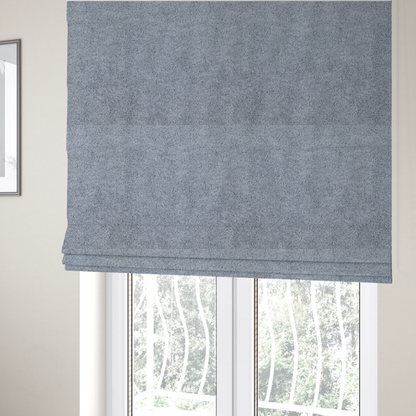 The fabric used to create these Roman blinds is a soft greyish-blue fabric with a dense, uniform, textured pile like thick fleece.