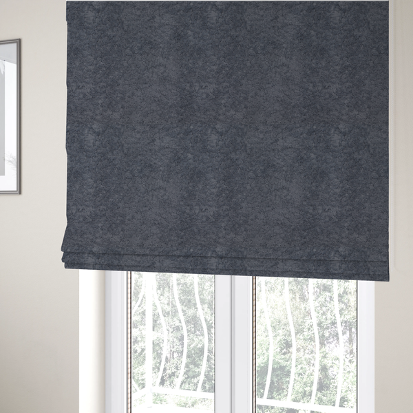The fabric used to create these Roman blinds is a plush shark grey fabric with a dense, uniform, textured pile like thick fleece.