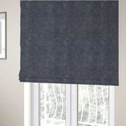 The fabric used to create these Roman blinds is a plush shark grey fabric with a dense, uniform, textured pile like thick fleece.