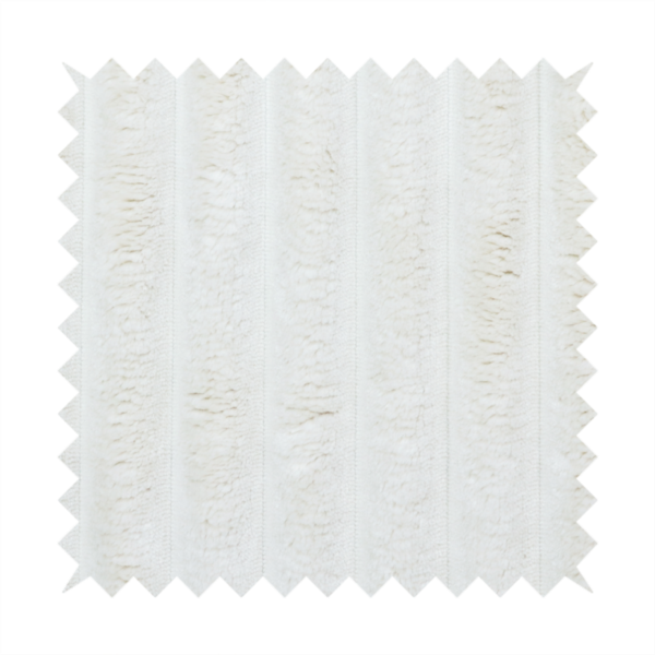 A cream-coloured textile featuring a repeating, vertical ribbed pattern. The fabric alternates between wide, soft, faux-fur-like plush bands and narrow, smooth, flat channels.