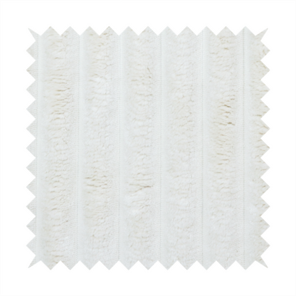 A cream-coloured textile featuring a repeating, vertical ribbed pattern. The fabric alternates between wide, soft, faux-fur-like plush bands and narrow, smooth, flat channels.