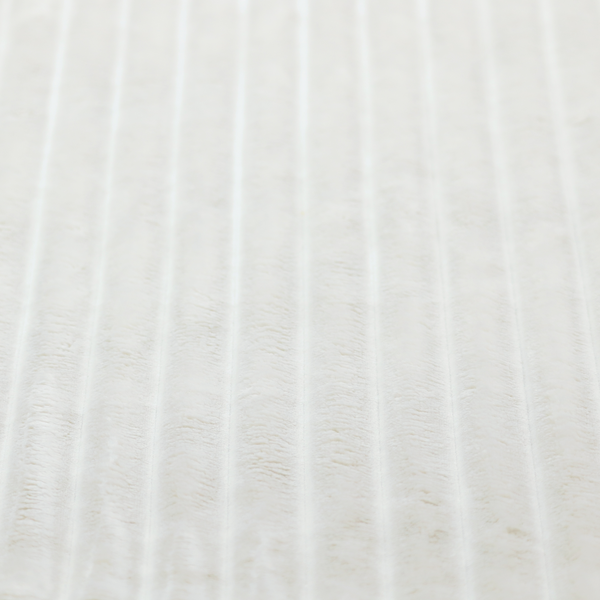 A cream-coloured textile featuring a repeating, vertical ribbed pattern. The fabric alternates between wide, soft, faux-fur-like plush bands and narrow, smooth, flat channels.