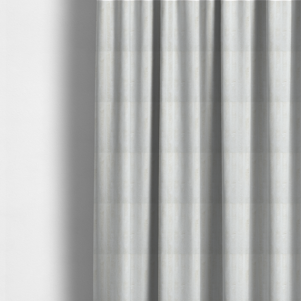 The fabric used to create these made-to-measure curtains is a cream-coloured textile featuring a repeating, vertical ribbed pattern. The fabric alternates between wide, soft, faux-fur-like plush bands and narrow, smooth, flat channels.