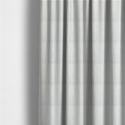 The fabric used to create these made-to-measure curtains is a cream-coloured textile featuring a repeating, vertical ribbed pattern. The fabric alternates between wide, soft, faux-fur-like plush bands and narrow, smooth, flat channels.