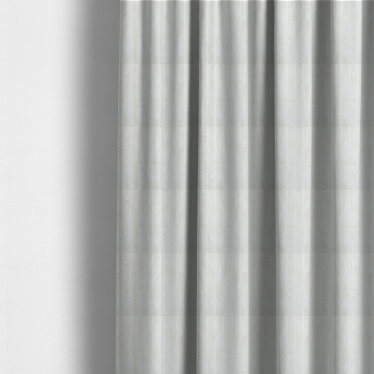 The fabric used to create these made-to-measure curtains is a cream-coloured textile featuring a repeating, vertical ribbed pattern. The fabric alternates between wide, soft, faux-fur-like plush bands and narrow, smooth, flat channels.