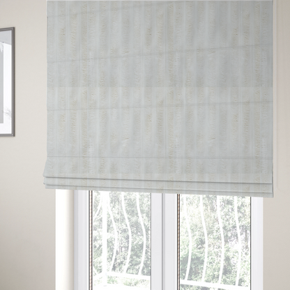 The fabric used to create these Roman blinds is a cream-coloured textile featuring a repeating, vertical ribbed pattern. The fabric alternates between wide, soft, faux-fur-like plush bands and narrow, smooth, flat channels.