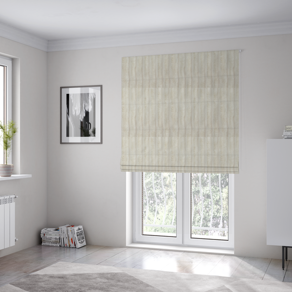 The fabric used to create these Roman blinds is a detailed view of a light beige or cream-coloured textile featuring a repeating, vertical channel-tufted pattern. The material alternates between soft, high-pile plush bands and thin, compressed vertical lines.