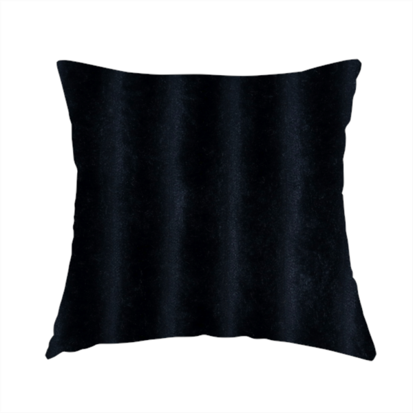 The fabric used to create this handmade cushion is a deep black textile featuring a repeating, vertical channel-tufted pattern. The fabric alternates between thick, high-pile plush bands and thin, compressed vertical channels.