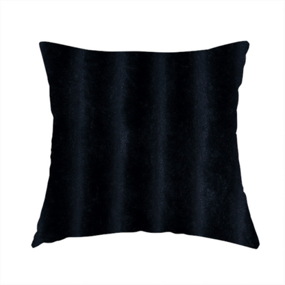 The fabric used to create this handmade cushion is a deep black textile featuring a repeating, vertical channel-tufted pattern. The fabric alternates between thick, high-pile plush bands and thin, compressed vertical channels.