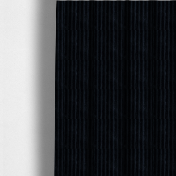 The fabric used to create these made-to-measure curtains is a deep black textile featuring a repeating, vertical channel-tufted pattern. The fabric alternates between thick, high-pile plush bands and thin, compressed vertical channels.