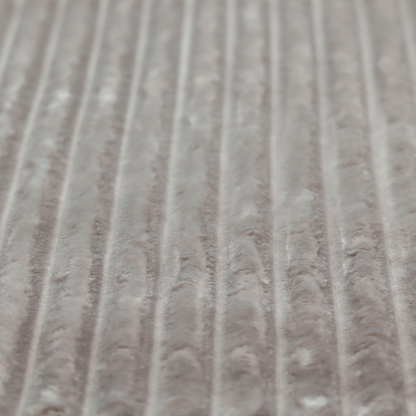 A grey textile featuring a repeating, vertical channel-tufted pattern that alternates between soft, high-pile bands and narrow, flat lines.