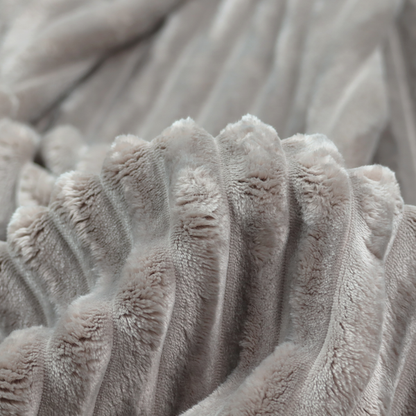 A grey textile featuring a repeating, vertical channel-tufted pattern that alternates between soft, high-pile bands and narrow, flat lines.