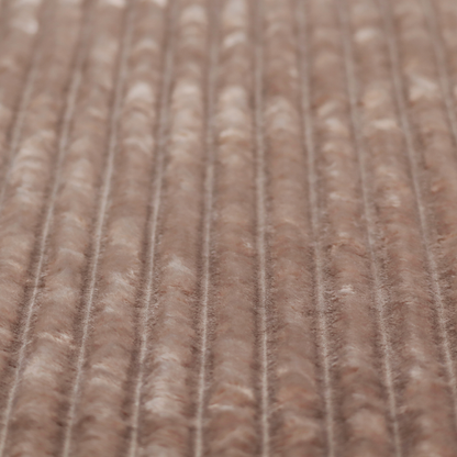 A warm, taupe-coloured textile featuring a repeating, vertical channel-tufted pattern that alternates between soft, high-pile bands and narrow, flat lines.